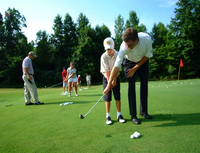 http://Golf%20instructor%20teaching%20a%20child